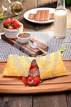 Strawberry pastry with chocolate Pastel de morango com chocolate - Traditional Brazilian photo