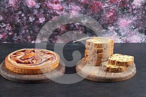 Strawberry pie and sultana pie slices on wooden boards
