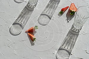 Strawberry pieces and glasses on the table