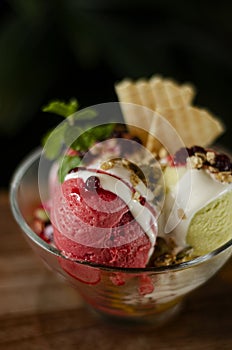 Strawberry and pistachio gelato ice cream sundae dessert in bowl