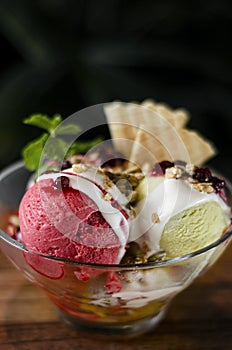 Strawberry and pistachio gelato ice cream sundae dessert in bowl