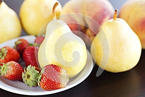 Strawberry in plate, pear and peach