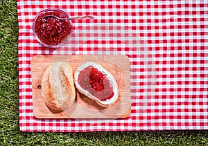 Strawberry preserve with a fresh crusty roll