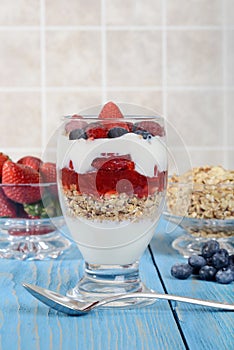 Strawberry raspberry blueberry parfait with berries and granola