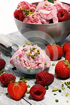 Strawberry and raspberry ice cream scoop with chopped nuts and w