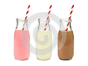 Strawberry regular and chocolate milk in bottles isolated