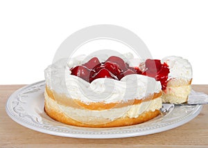 strawberry short cake on plate with slice being pulled out