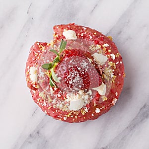 Strawberry shortcake donut on marble surface