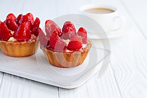 Strawberry shortcake pies strawberries tartlets with custard on white wooden background