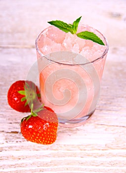 Strawberry slush in glass with fruits and mint