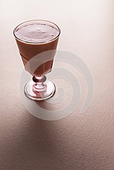 Strawberry smoothie glass on pink background. Fresh summer smoothie
