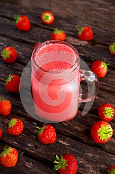 Strawberry smoothie in jar glass on wooden table. healthy food concept for breakfast or snack.