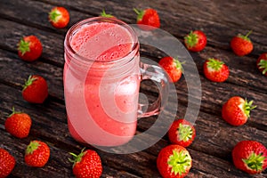 Strawberry smoothie in jar glass on wooden table. healthy food concept for breakfast or snack.