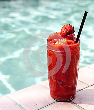 Strawberry smoothie by the swimming pool