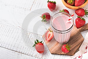 Strawberry smoothie. Vegan smoothie or milkshake from strawberry, banana and mint on white wooden table background. Clean eating,