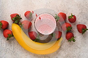 Strawberry smoothie. Vegan smoothie or milkshake from strawberry, banana and mint on white wooden table background. Clean eating,