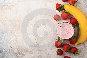 Strawberry smoothie. Vegan smoothie or milkshake from strawberry, banana and mint on white wooden table background. Clean eating,