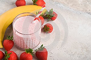 Strawberry smoothie. Vegan smoothie or milkshake from strawberry, banana and mint on white wooden table background. Clean eating,