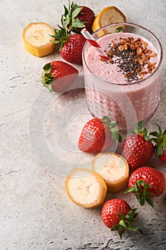 Strawberry smoothie. Vegan smoothie or milkshake from strawberry, banana and mint on white wooden table background. Clean eating,