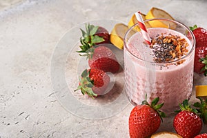 Strawberry smoothie. Vegan smoothie or milkshake from strawberry, banana and mint on white wooden table background. Clean eating,