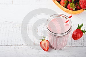 Strawberry smoothie. Vegan smoothie or milkshake from strawberry, banana and mint on white wooden table background. Clean eating,