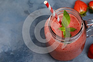 Strawberry smoothies with banana and orange juice in a glass jar