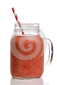 Strawberry smoothies with banana and strawberries in a glass jar