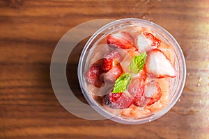 Strawberry smoothies in plastic cup. Refreshment healthy drink.