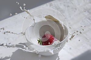 Strawberry splashing in the cup of milk