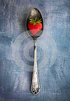 Strawberry on a spoon.