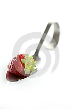 Strawberry in a spoon photo