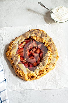 Strawberry summer galette with puf pastry and almond flakes