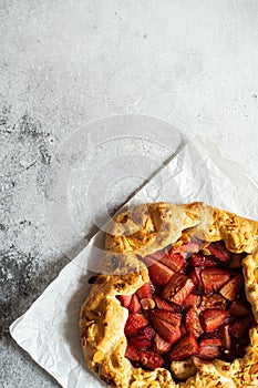 Strawberry summer galette with puf pastry and almond flakes. Copy space and top view