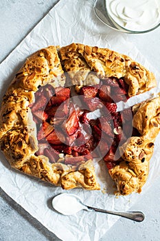 Strawberry summer galette with puf pastry and almond flakes with cream