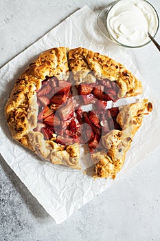 Strawberry summer galette with puf pastry and almond flakes with cream