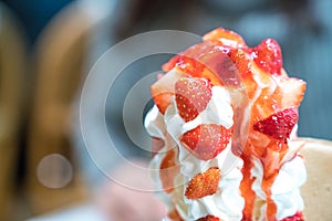 Strawberry sundae tower ice-cream with whip cream and strawberry sauce