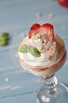 Strawberry sundae with vanilla sauce and mint