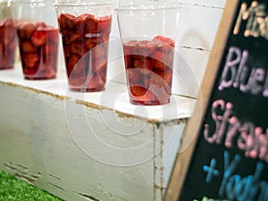 Strawberry and syrup in the plastic glass show on the shelf prepare for made to smoothies by the customer order