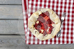 Strawberry tart on checked red and white table cloth