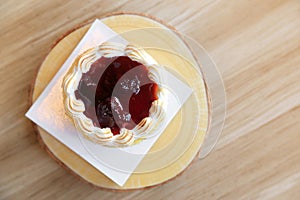 Strawberry tart pie on wooden plate.