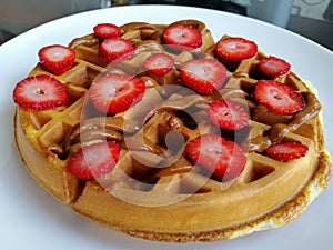 Strawberry topped waffles with dulce de leche