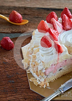Strawberry And Vanila Ice Cream Cake With Fresh Strawberry Topping On Wooden Table