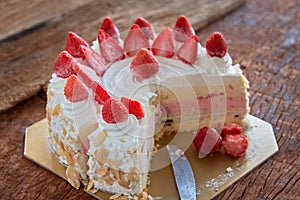 Strawberry And Vanila Ice Cream Cake With Fresh Strawberry Topping On Wooden Table photo