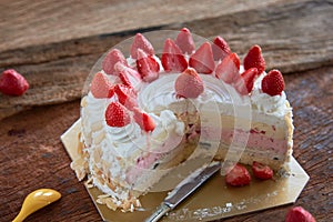 Strawberry And Vanila Ice Cream Cake With Fresh Strawberry Topping On Wooden Table