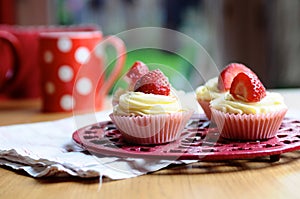 Strawberry and Vanilla Cupcakes on Kitchen Table