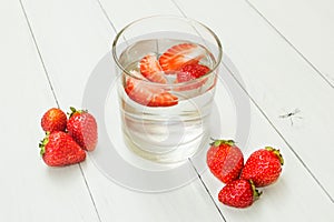 Strawberry water on a light white table. Detox, a healthy lifestyle. Fresh drink