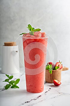 Strawberry watermelon smoothie or slushie in a tall cup