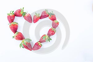 Strawberry on white background fruit`s healthful cordial, useful