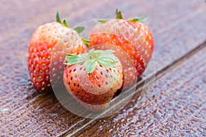 Strawberry on wood with water drop