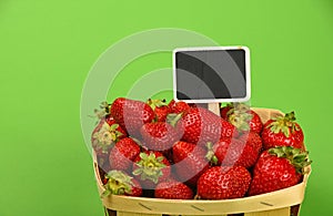 Strawberry in wooden basket with price sign